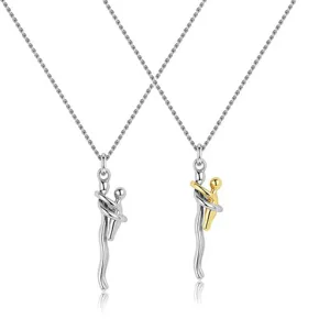 Detailed view of silver and gold-accented parent-child hugging pendant necklaces