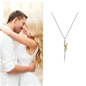 Detail of a two-tone hug pendant necklace, symbolizing love and connection as a sentimental gift.