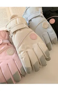 Close-up detail of thermal winter ski gloves featuring soft plush lining and non-slip grip palms.