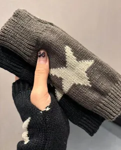 Close-up detail of winter knitted fingerless gloves with cozy star pattern and warm fabric.