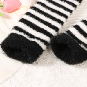 Cozy black and white striped knitted furry arm warmers detail view, soft plush winter accessory