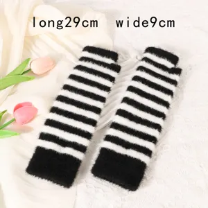 Detailed close-up of black and white striped knit arm warmers, showing fuzzy texture and knit details.