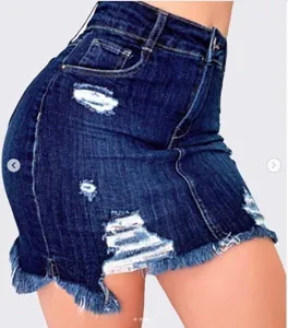Close-up detail view of women's dark blue denim mini skirt, distressed rip design and frayed hem.