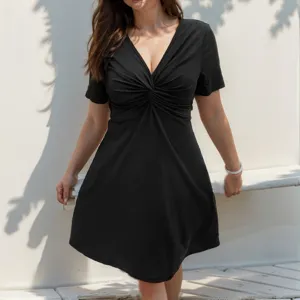 Detailed close up view of women black short sleeve V neck twist front casual mini dress.
