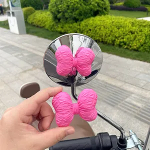 Pink quilted bow accessory detail for electric scooter and motorcycle rearview mirror decoration.
