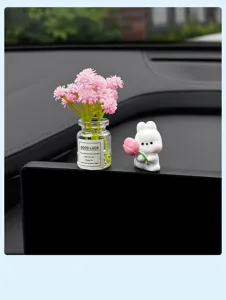 Cute rabbit figurine and mini flower vase dashboard decor, perfect for car interior aesthetics.