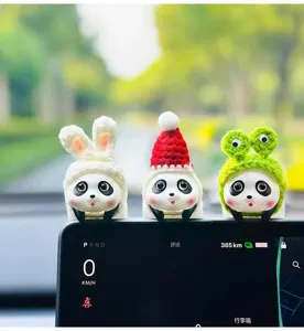 Cute panda car dashboard ornaments with funny hats, detailed close-up shot for interior.