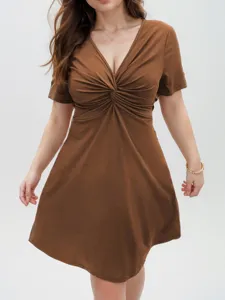 Detailed view of the brown short sleeve V-neck twist knot dress showcasing fine fabric texture.