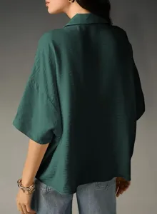 Back view detail of dark green loose short sleeve shirt with turn down collar for summer style.
