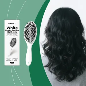 White handle cushion hairbrush detail view, featuring boar bristles for daily styling and care.
