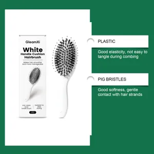Detail view of cushion hairbrush handle, featuring soft pig bristles and durable plastic build.