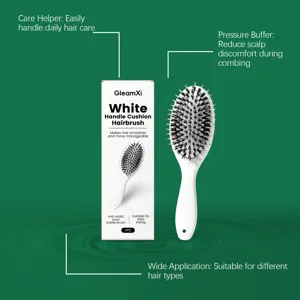 Detail view of the hairbrush showing nylon and boar bristles on a soft cushion for scalp care.