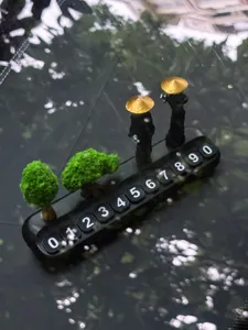 Car temporary parking card with martial arts figures and miniature trees decoration.