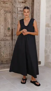 Detailed view of the elegant black sleeveless maxi dress featuring a chic U-neck and drape.