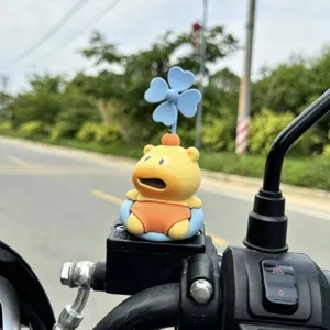 Cute capybara motorcycle ornament with spinning windmill and orange hat, fun bike accessory.