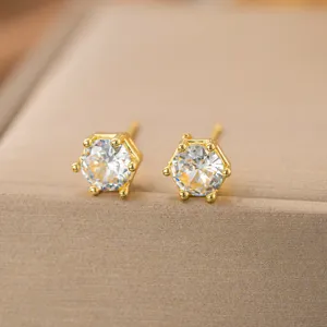 Makroaufnahme von luxuriösen goldfarbenen Blumen-Ohrsteckern mit klaren Zirkonsteinen
