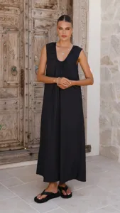 Close up of the elegant sleeveless black maxi dress featuring pleated neckline and flowy long hem.