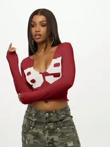 Detail view of the sexy U-neck long sleeve crop top with bold chest graphic print. Perfect Y2K style.