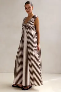 Detail view of the elegant brown and white striped sleeveless maxi dress in a flowy design.