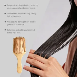 Bamboo hairbrush detail showing ergonomic wooden handle and gentle cushion scalp teeth.