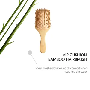 Detailed view of the bamboo hairbrush showing smooth wooden bristles and air cushion design.