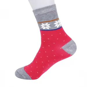 Close-up of winter warm mid-tube cotton socks with nordic snowflake and dot pattern details.