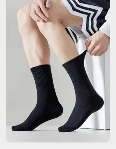 Detail view of men's black crew socks, breathable cotton material, ribbed cuff design.