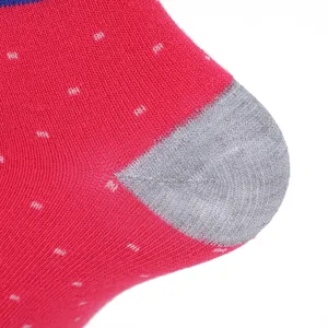 Close-up detail of thick warm cotton socks featuring red polka dot pattern and gray heel.