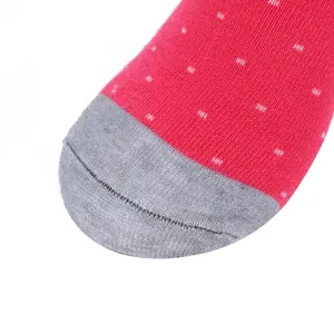 Close up detail of winter warm thick cotton sock toe, pink with white dots and grey.
