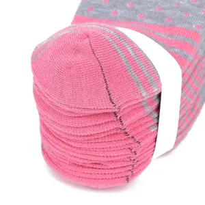 Detailed close-up of thickened winter warm cotton socks in pink and grey with neat stacking.