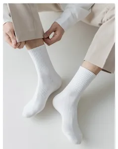 Detailed view of men's white ribbed crew socks, comfortable pure cotton casual sports style.