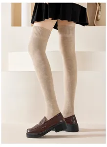 Thickened over-the-knee knit socks detail shot, soft beige winter warm leg wear style.