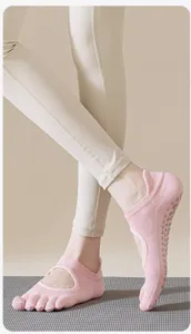 Detailed view of pink breathable backless five toe yoga socks with grip soles for women.