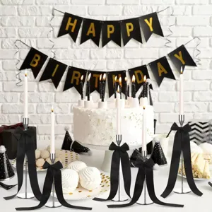 Metal candle holders with black ribbon bows, elegant taper candlestick set for party decor.