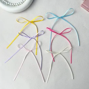 Close-up detail of colorful ribbon bows, pastel satin bow ornaments for baking and DIY crafts.