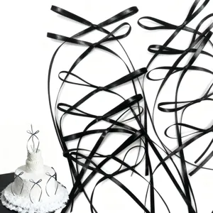 Black ribbon cake topper bows set, elegant corset style baking decorations for birthday parties.