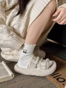 Cozy winter fleece socks with cute cartoon embroidery detail, soft warm mid-tube design.