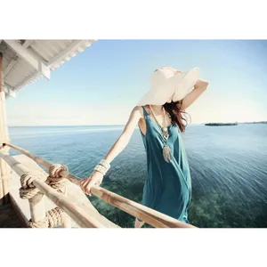 Wide-brim straw beach hat for women, perfect for summer sun protection and seaside vacation style.