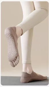 Detailed view of breathable non-slip five toe yoga socks with grip dots for pilates and dance.