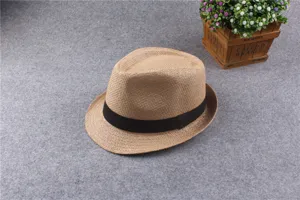 Detailed view of classic straw fedora hat with black band, stylish sun protection sunhat.
