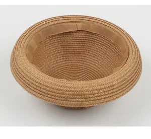 Detail view of the inner sweatband and straw woven texture of a classic brown summer hat.