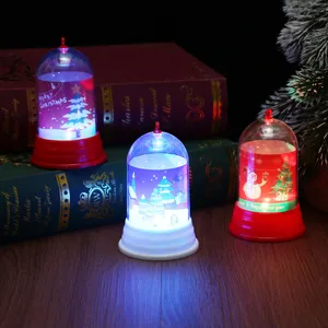 Christmas LED night light detail, transparent dome with cute snowman and tree design.