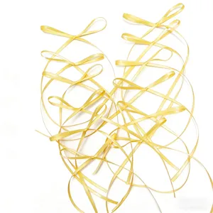 Yellow ribbon bows detail shot, perfect for cake decoration, baking, and festival gift wrapping.