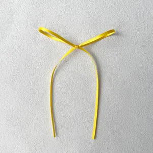 Yellow ribbon bow detail shot, fine 0.3cm width, perfect for cake and dessert decoration.
