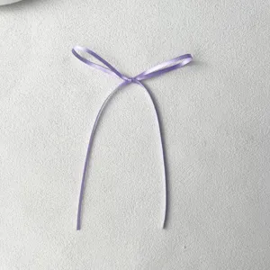 Close up of light purple ribbon bow detail for baking cake decoration aesthetic props.