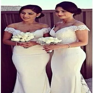 Detail view of elegant off-shoulder white lace mermaid bridesmaid evening dress scenery.