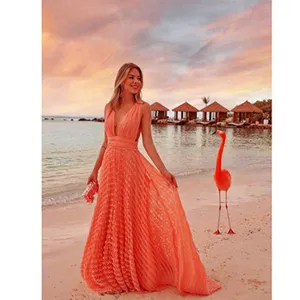 Stunning sunset beach resort scene featuring an elegant long orange dress with a deep V neck.