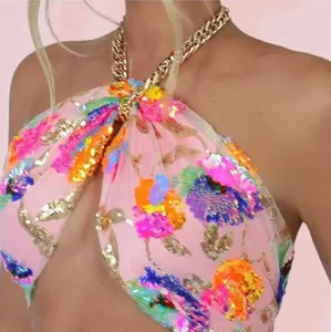 Close-up view of the sexy colorful sequin embroidered halter top with gold chain detail.