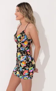 Black sequin mini dress with colorful floral embroidery and chic spaghetti straps detail.