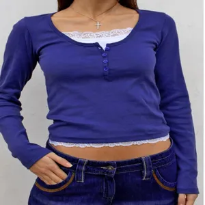 Women's slim fit long sleeve t-shirt with fake two piece lace trim and button Henley design.